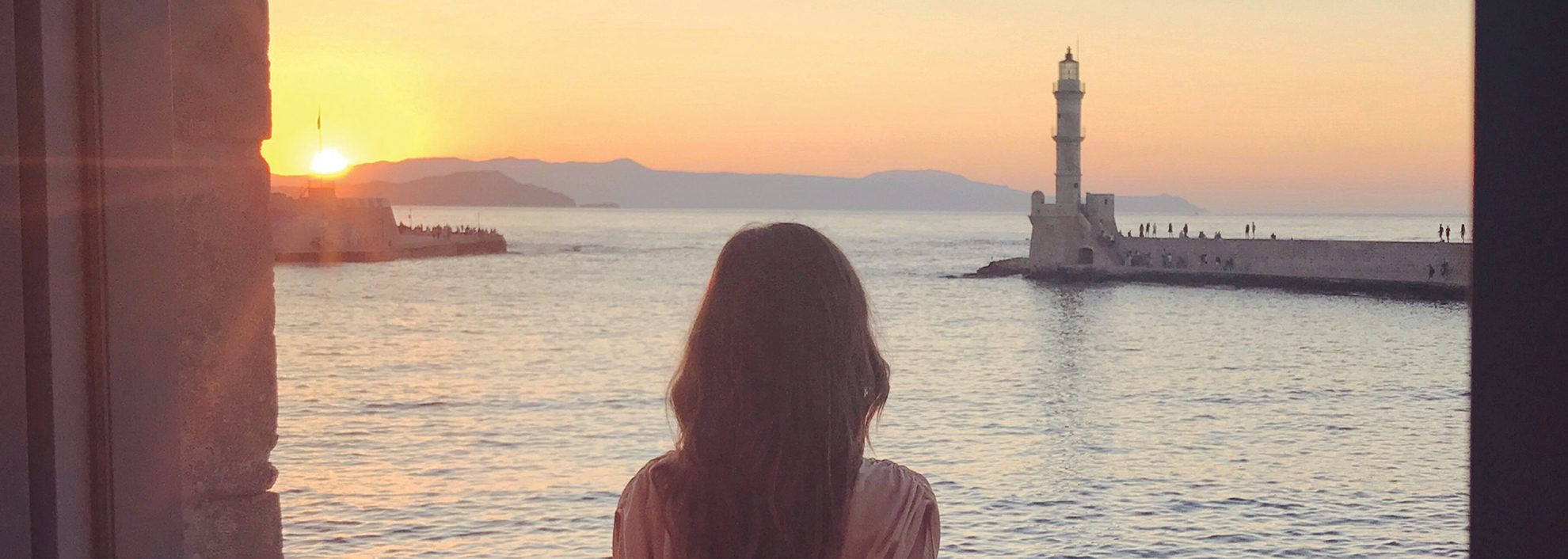 Woman on balcony at sunset